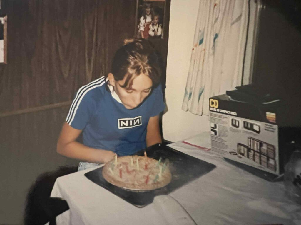 Teen wearing a Nine Inch Nails shirt during a 1990s birthday celebration