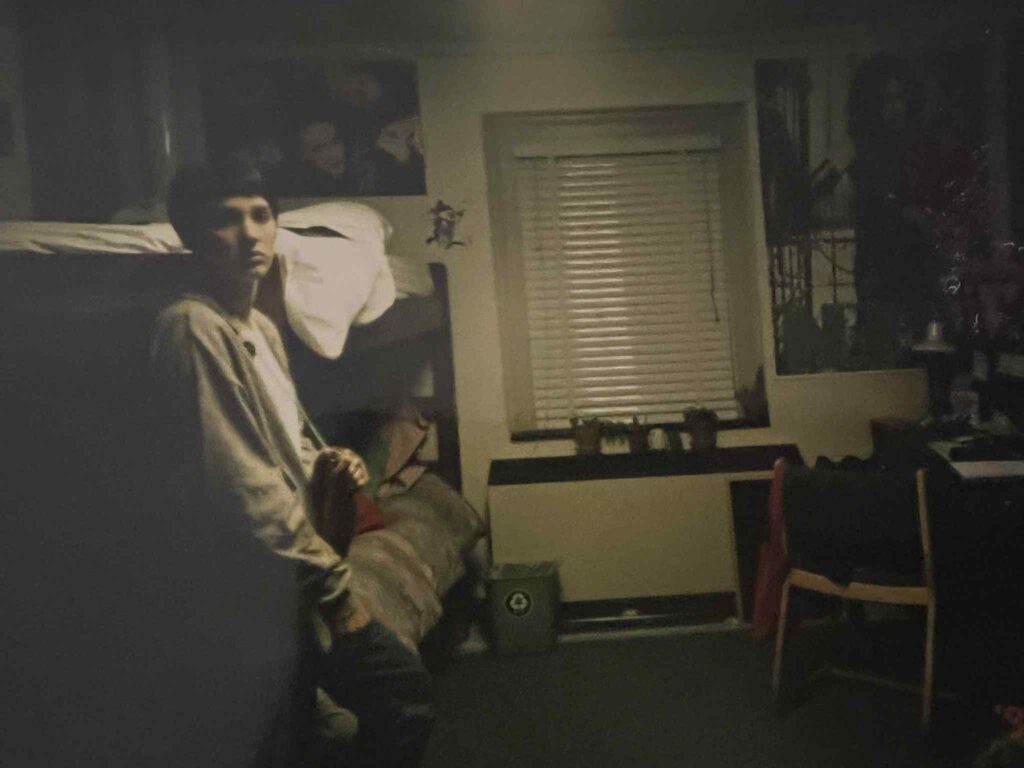 1990s college dorm room decorated with posters and music memorabilia